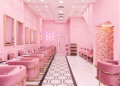 Chic pink interior of BOA Beauty Bar Buitengracht Street, Cape Town, Western Cape, ZA, featuring plush seating and floral decor.