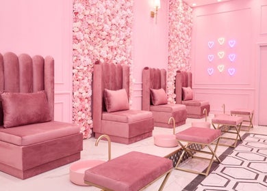 Elegant seating area at BOA Beauty Bar Ballito, Ballito, Kwazulu-natal, ZA with pink chairs and floral wall.