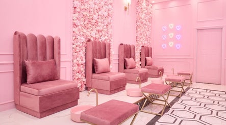 Elegant seating area at BOA Beauty Bar Ballito, Ballito, Kwazulu-natal, ZA with pink chairs and floral wall.