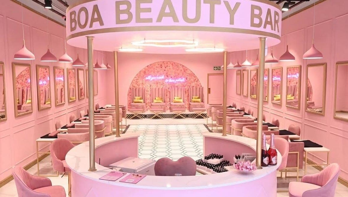 Chic interior of BOA Beauty Bar Mall Of The South, Alberton, Gauteng, ZA with elegant pink decor and seating.
