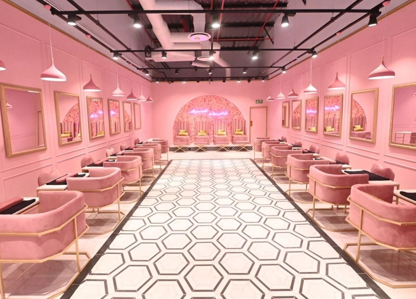Chic pink interior of BOA Beauty Bar Mall Of The South, Alberton, Gauteng, ZA, featuring modern salon stations.