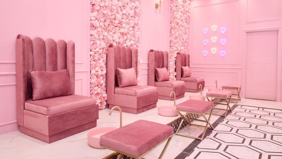 Elegant pink pedicure lounge at BOA Beauty Bar Sandown in Cape Town, Western Cape, ZA with velvet chairs and floral wall.
