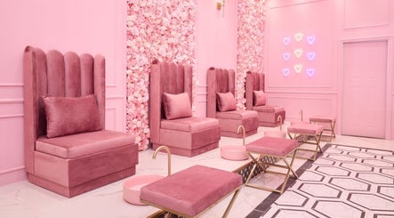 Elegant pink pedicure lounge at BOA Beauty Bar Sandown in Cape Town, Western Cape, ZA with velvet chairs and floral wall.