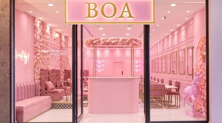 Chic pink interior of BOA Beauty Bar Sandown, Cape Town, Western Cape, ZA with plush seating and floral décor.