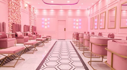 Elegant pink seating at BOA Beauty Bar Sandown, Cape Town, Western Cape, ZA, with floral walls and neon accents.