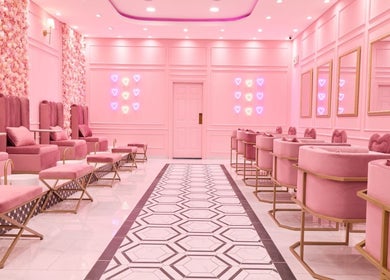 Lavish pink interior of BOA Beauty Bar Mushroom Farm in Midrand, Gauteng, ZA with plush seating and neon accents.