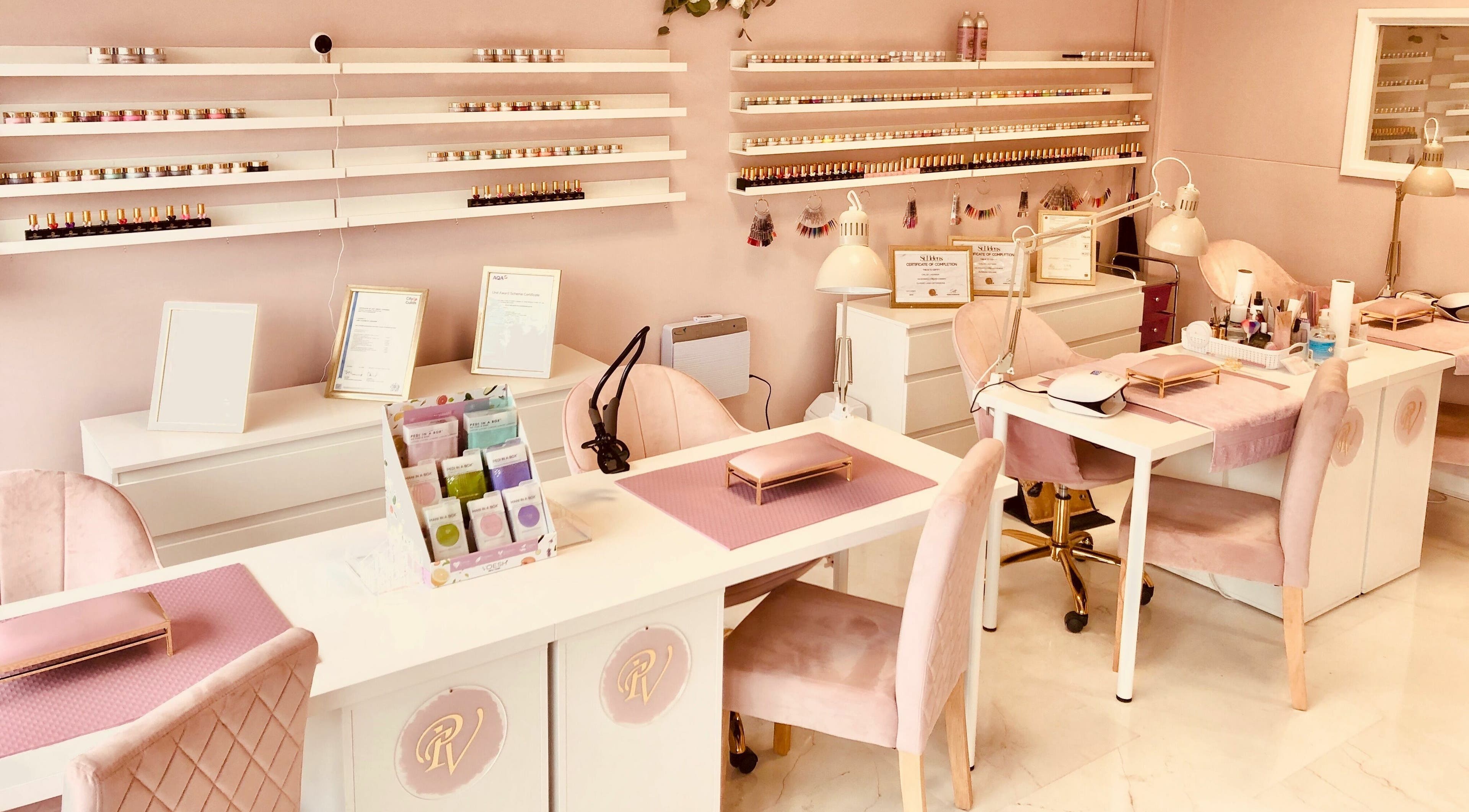 Interior of Pink Velvet Nails and Beauty, West Moors, England, with elegant nail stations and soft pink decor.