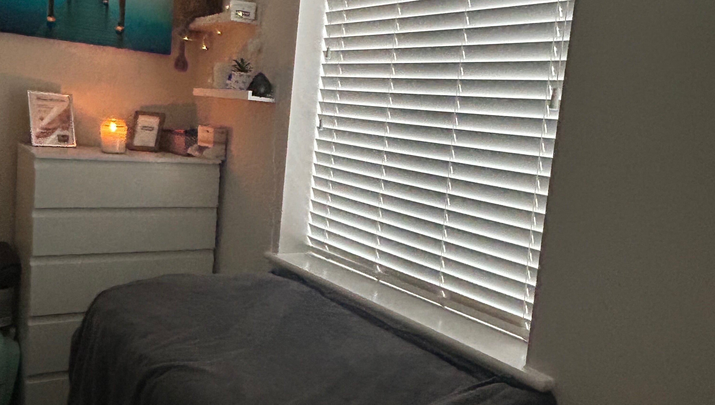 Cozy treatment room at Pristine Beauty By Jodie, Poole, England, GB with warm lighting and calming decor.