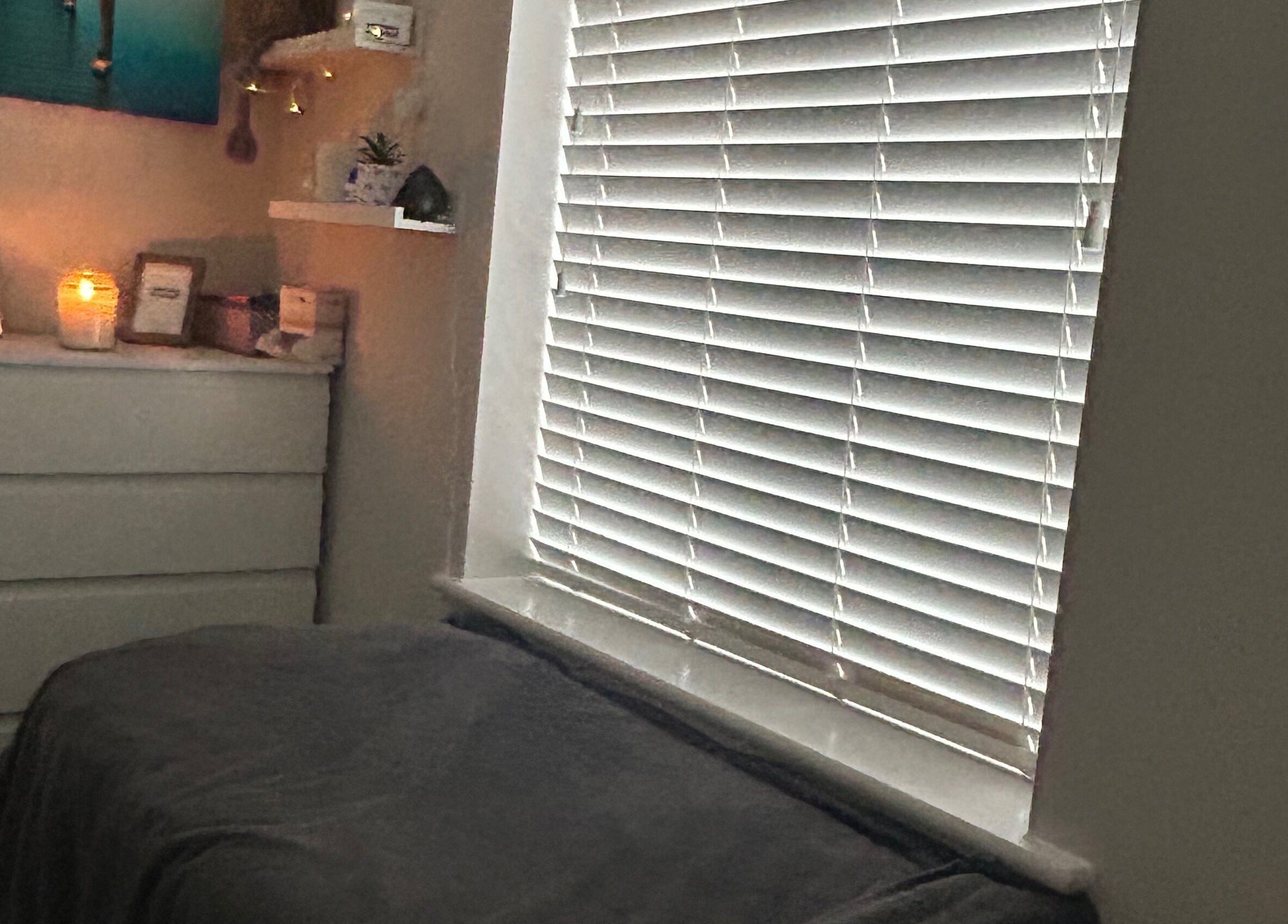 Cozy treatment room at Pristine Beauty By Jodie, Poole, England, GB with warm lighting and calming decor.