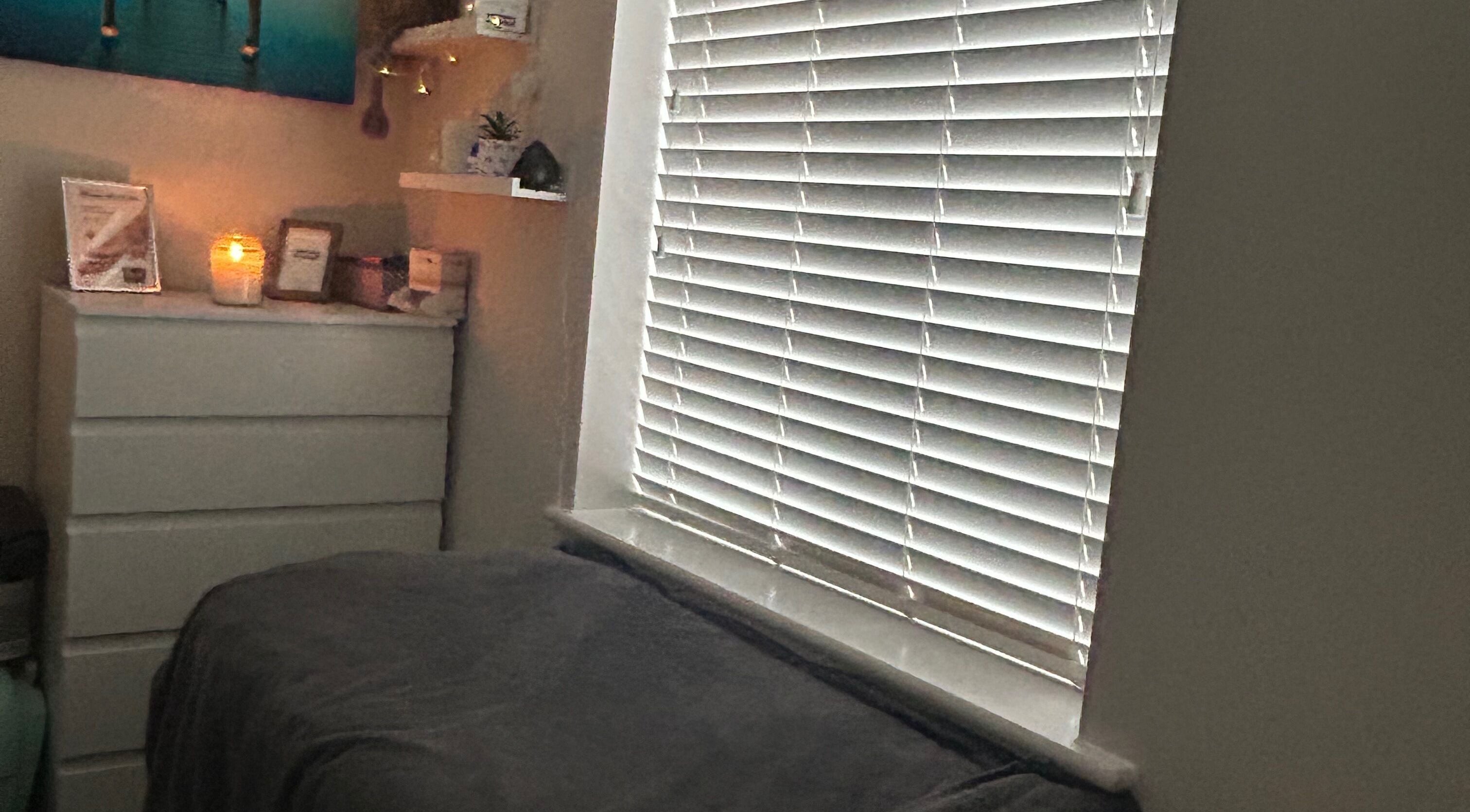 Cozy treatment room at Pristine Beauty By Jodie, Poole, England, GB with warm lighting and calming decor.