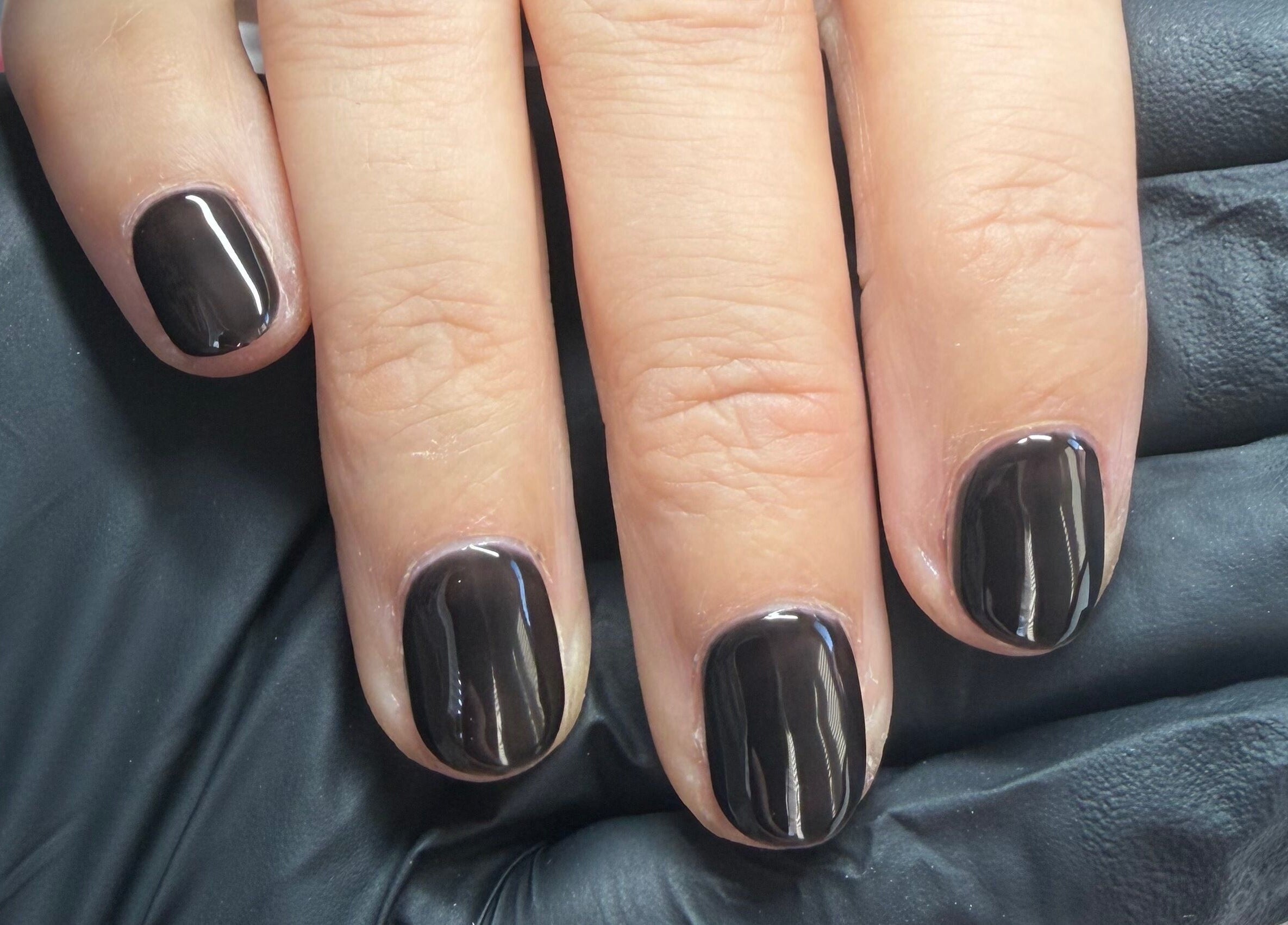 Sleek black manicure at Pristine Beauty By Jodie in Poole, England, GB. Stunning glossy finish on well-groomed nails.