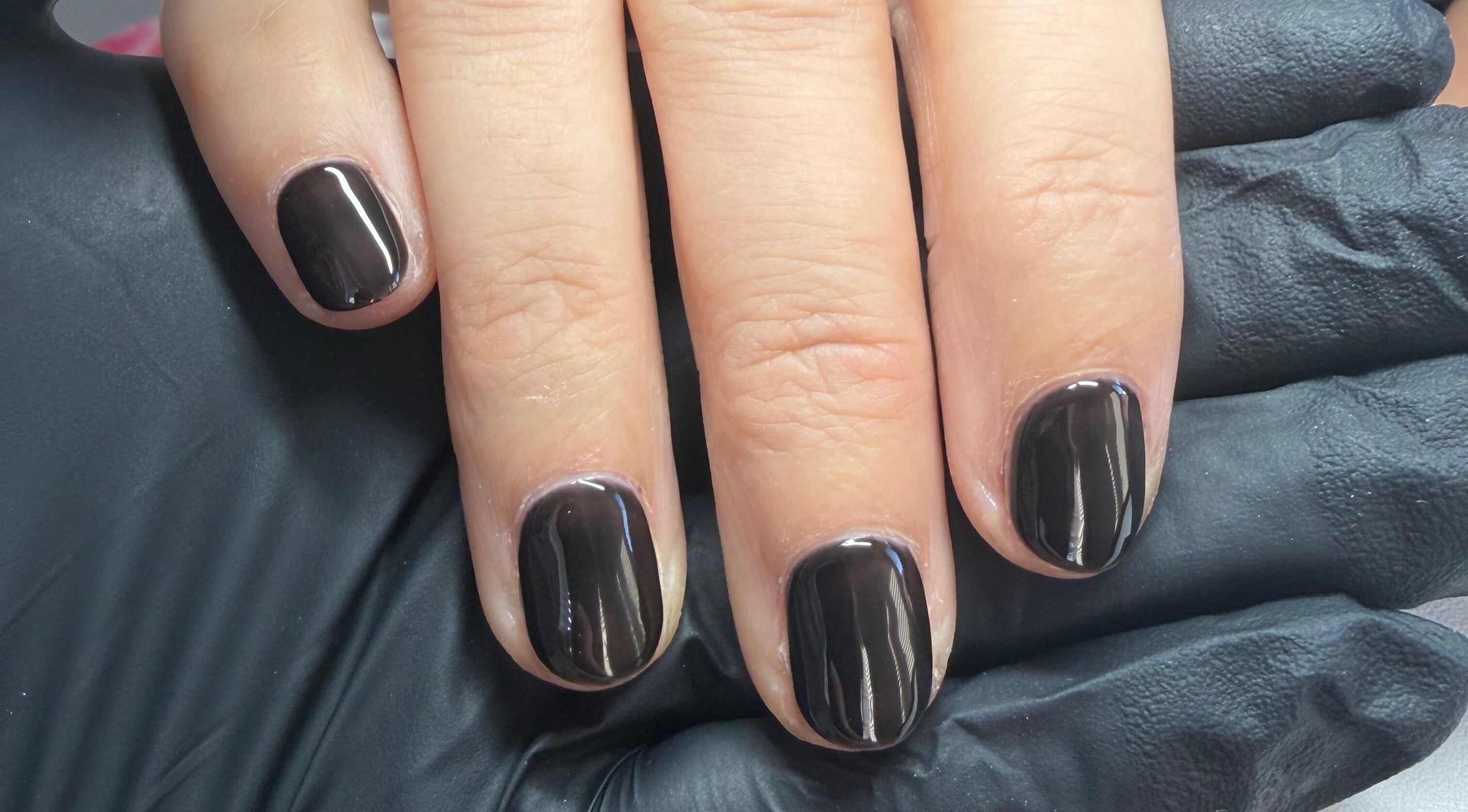 Sleek black manicure at Pristine Beauty By Jodie in Poole, England, GB. Stunning glossy finish on well-groomed nails.