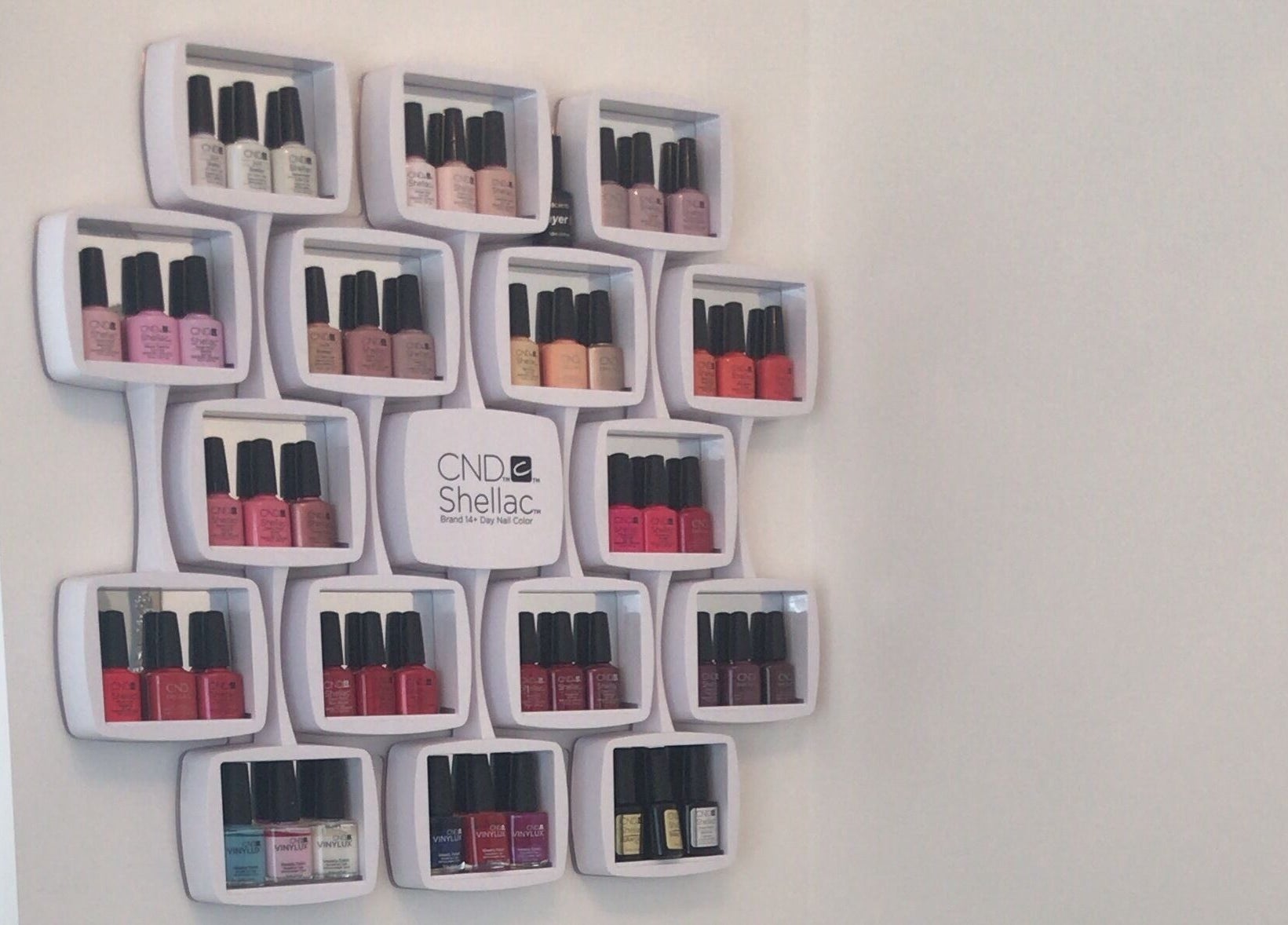 Chic nail polish rack at Pristine Beauty By Jodie in Poole, England, GB showcasing diverse colors.