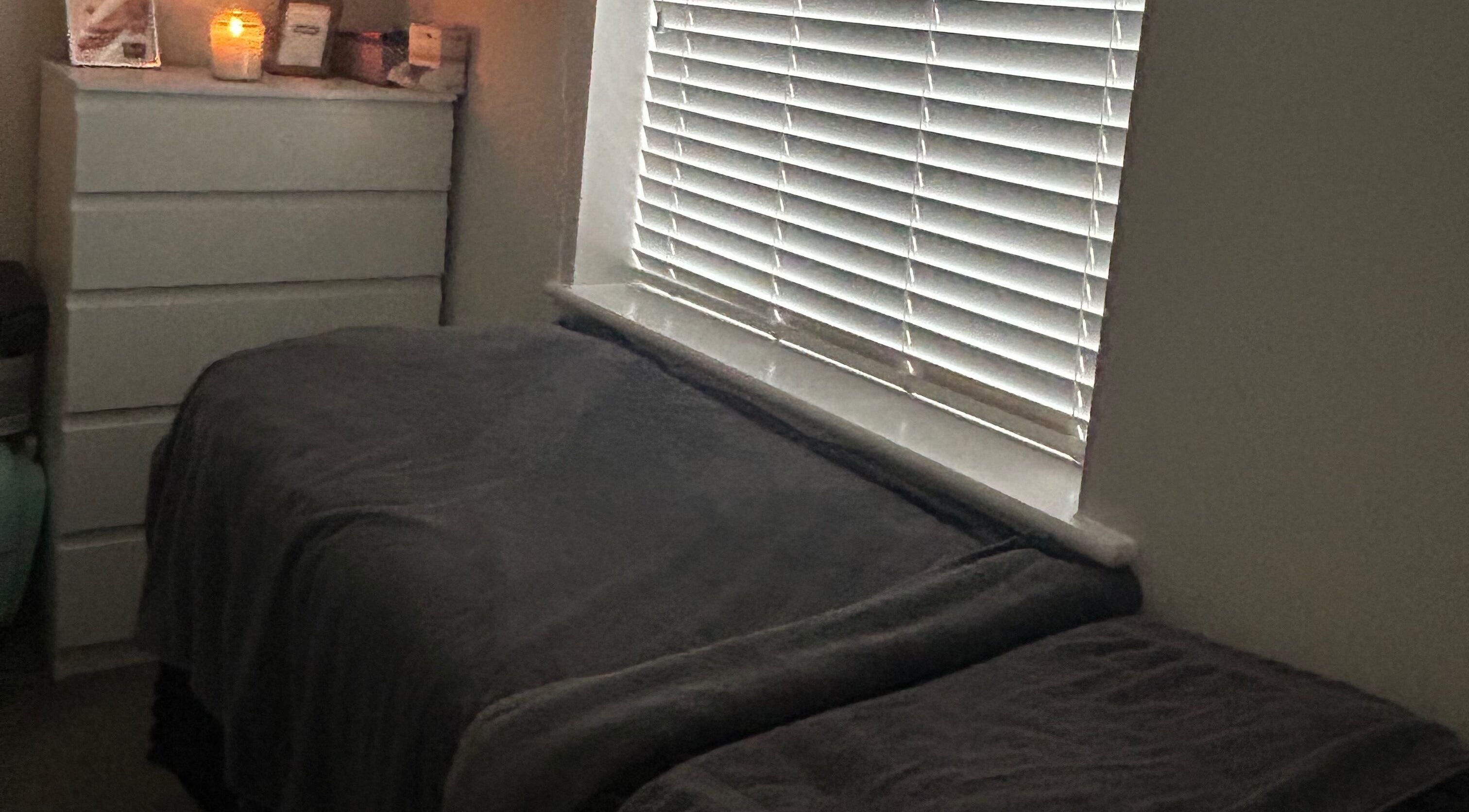 Cozy treatment room at Pristine Beauty By Jodie in Poole, England, GB, with soft lighting and comfortable bedding.