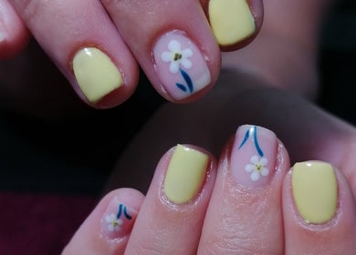 Chic yellow nails with floral art at Majestic Beauty Co, Cape Town, Western Cape, ZA.