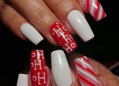 Elegant festive nail art at Majestic Beauty Co, Cape Town, Western Cape, ZA featuring red and white designs.