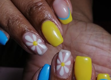 Vibrant daisy nail art at Majestic Beauty Co, Cape Town, Western Cape, ZA. Blue and yellow colors.