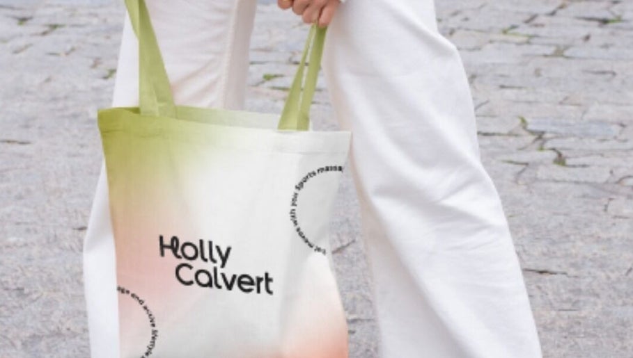 Person holding a stylish tote bag with 'Holly Calvert' logo near HC Sports Massage, Bailrigg, England, GB.