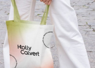 Person holding a stylish tote bag with 'Holly Calvert' logo near HC Sports Massage, Bailrigg, England, GB.