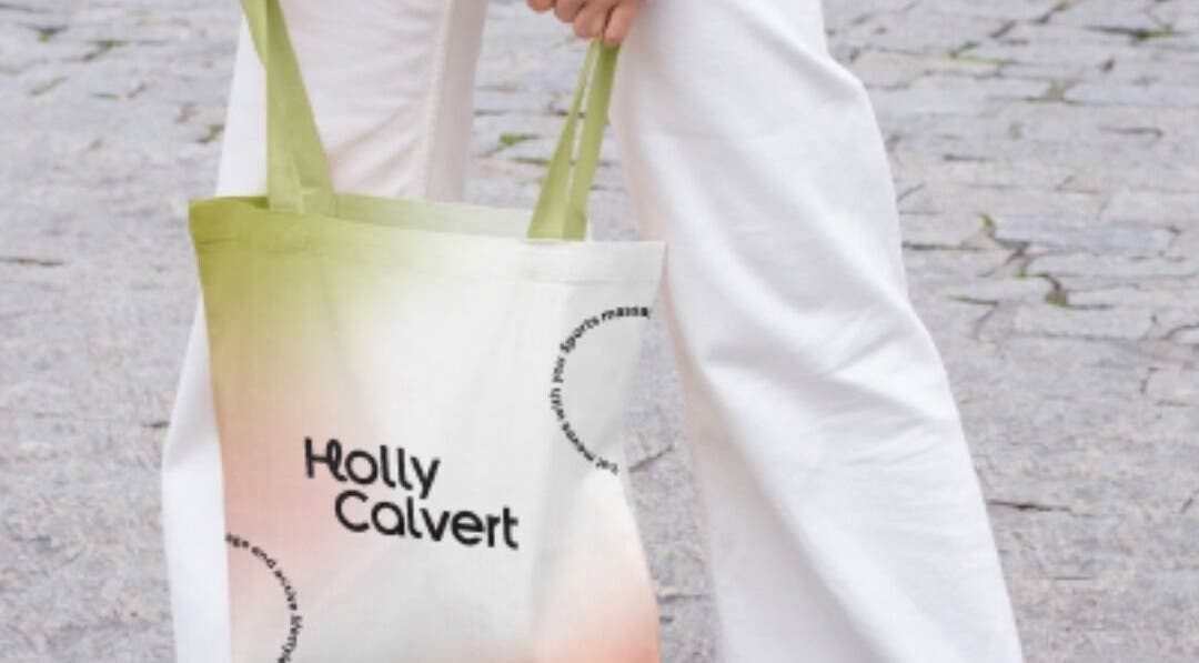Person holding a stylish tote bag with 'Holly Calvert' logo near HC Sports Massage, Bailrigg, England, GB.