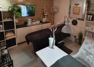 Elegant treatment room at Beauty by Anita in Tyldesley, England, GB featuring a cozy bed and decor.