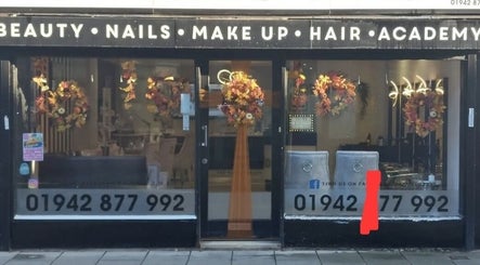 Front view of Beauty by Anita in Tyldesley, England, GB, adorned with autumn wreaths.