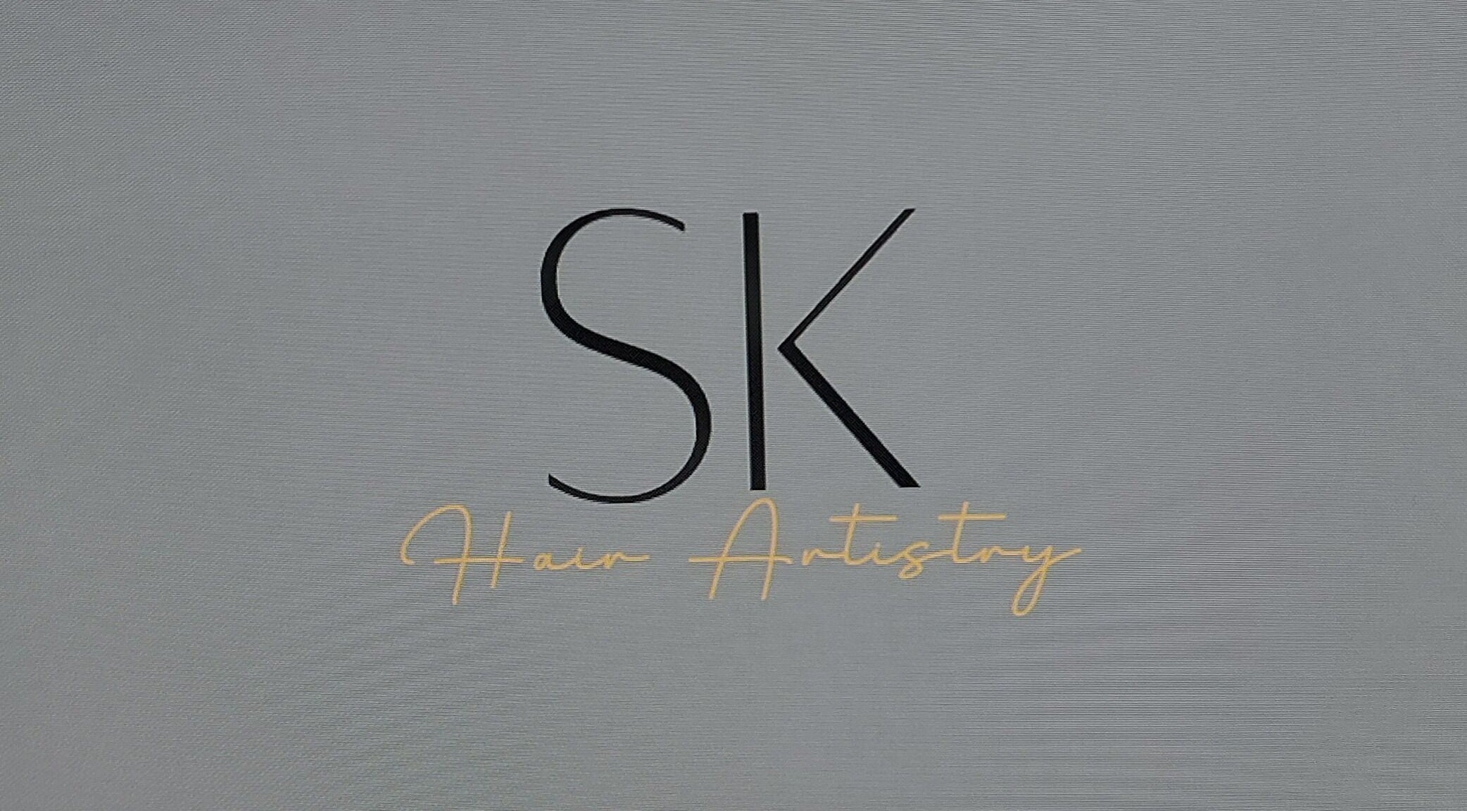 SK Hair Artistry logo in Iluka, Western Australia, AU, featuring elegant script on a textured background.