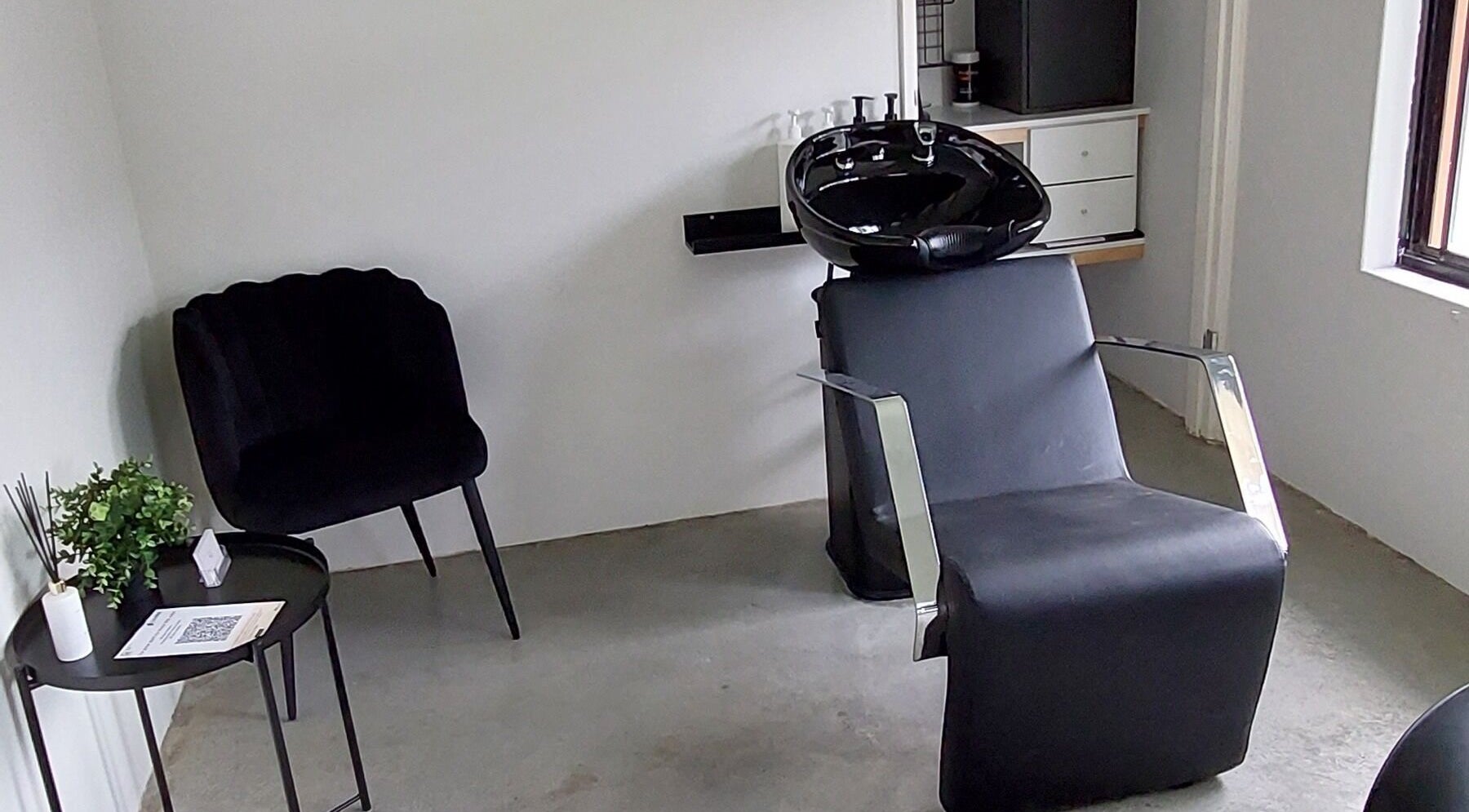 Modern salon space at SK Hair Artistry, Iluka, Western Australia, AU featuring chic seating and stylish decor.