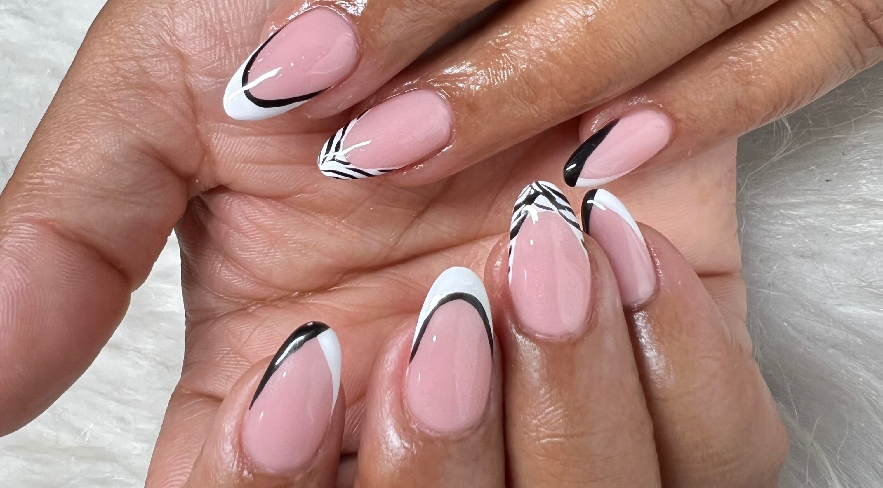 Elegant nail art at Arukah Beauty in Pietermaritzburg, Kwazulu-natal, ZA featuring black and white patterns.