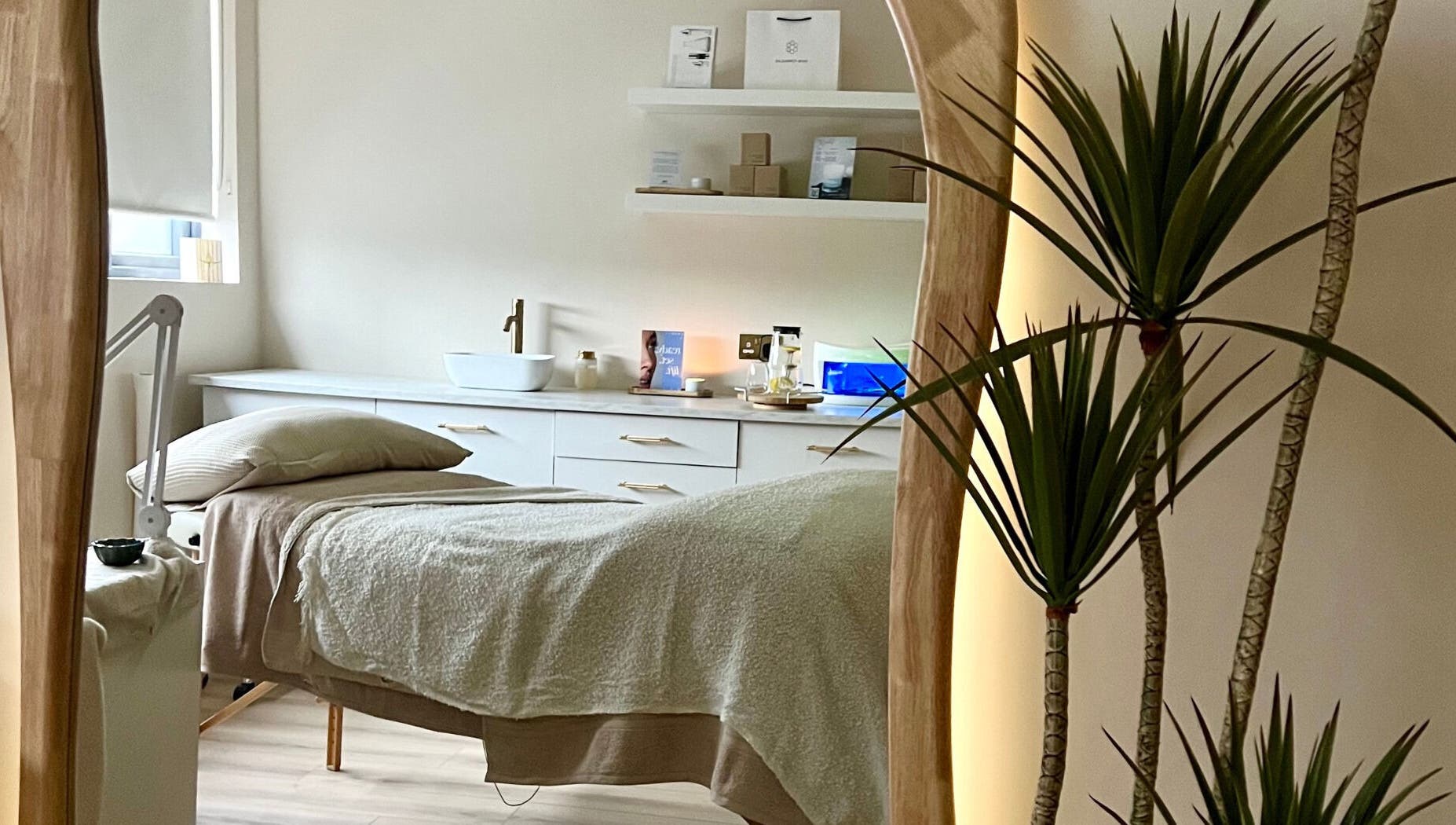 Serene treatment room at Beauty Lab, Drogheda, IE, featuring a massage bed and calming decor.