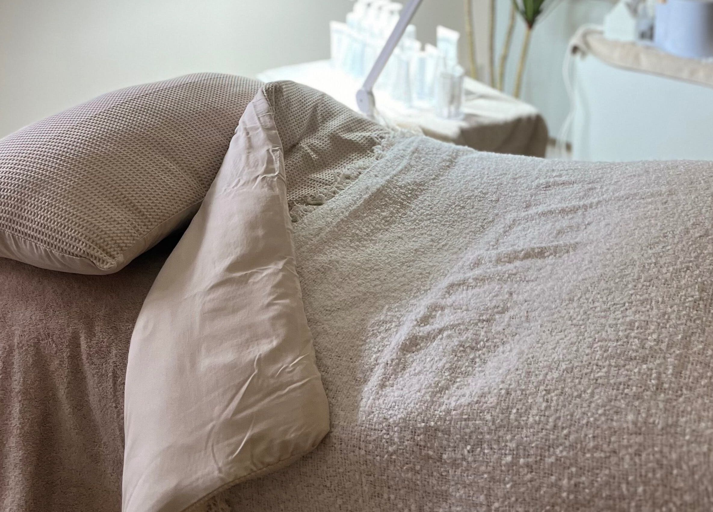 Relaxing treatment bed at Beauty Lab in Drogheda, IE, showcasing cozy linens for a peaceful experience.