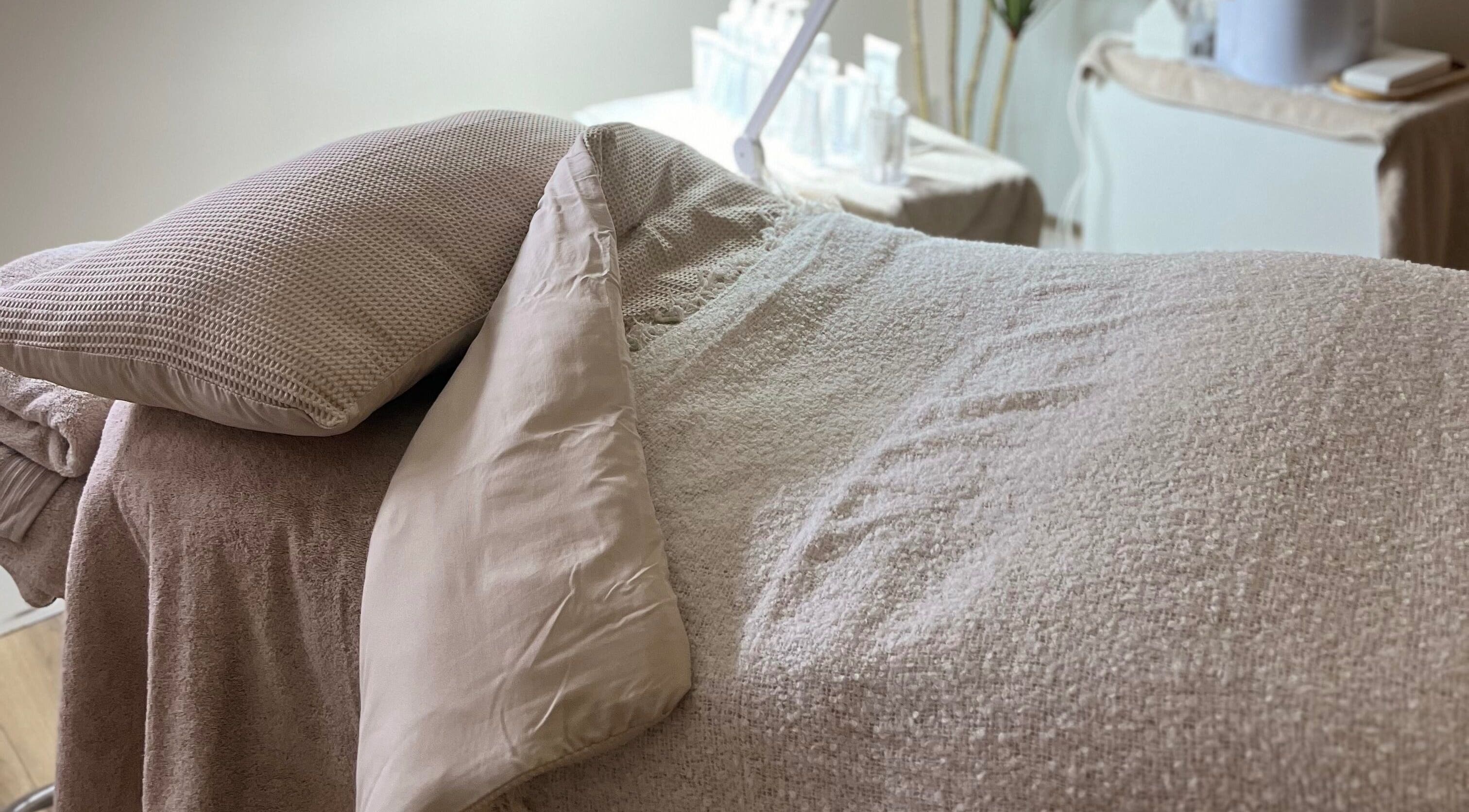 Relaxing treatment bed at Beauty Lab in Drogheda, IE, showcasing cozy linens for a peaceful experience.