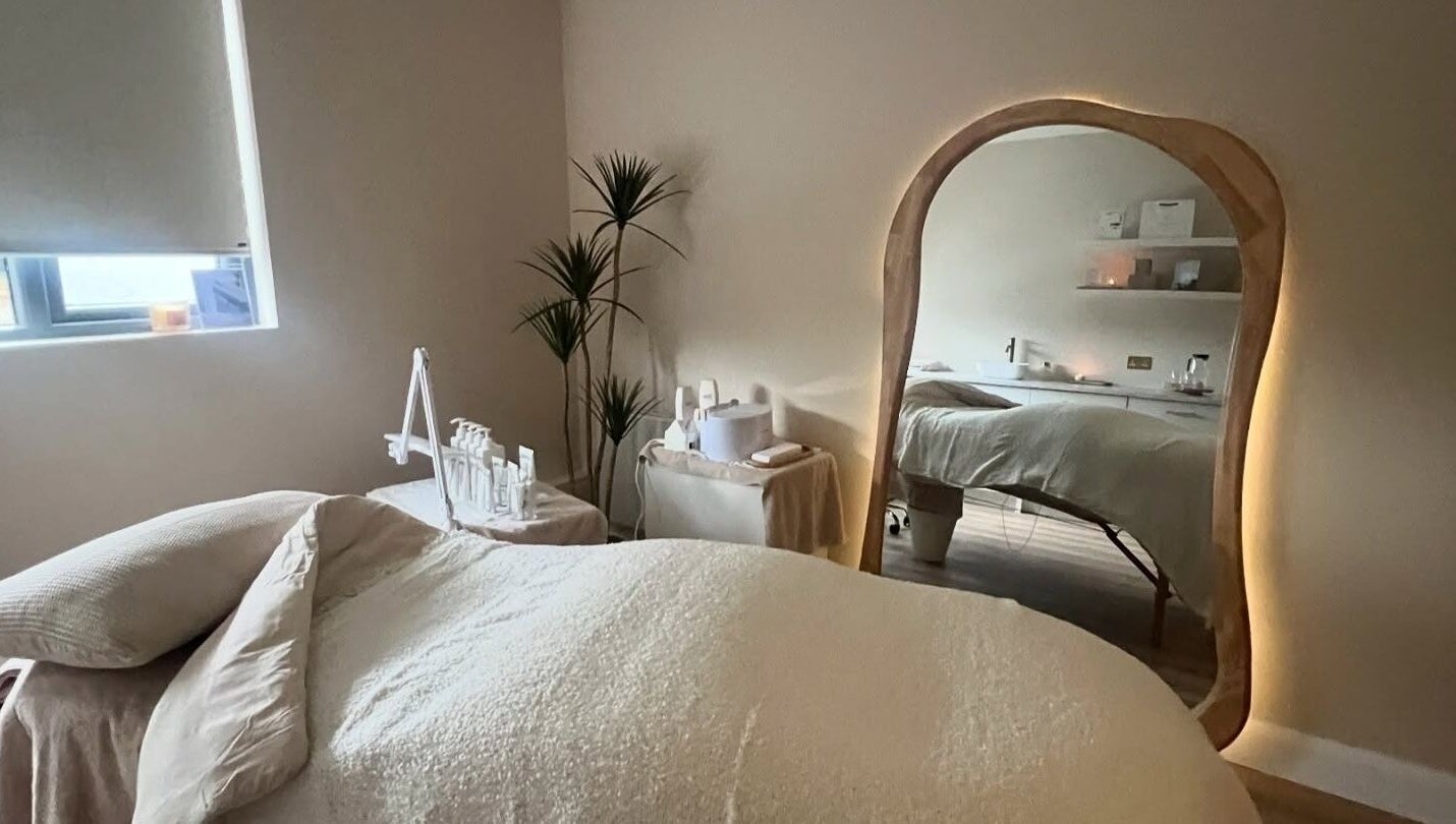Relaxing treatment room at Beauty Lab in Drogheda, IE with soft lighting and a cozy bed.