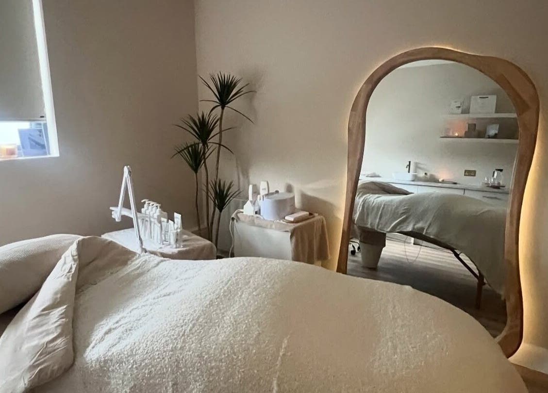 Relaxing treatment room at Beauty Lab in Drogheda, IE with soft lighting and a cozy bed.