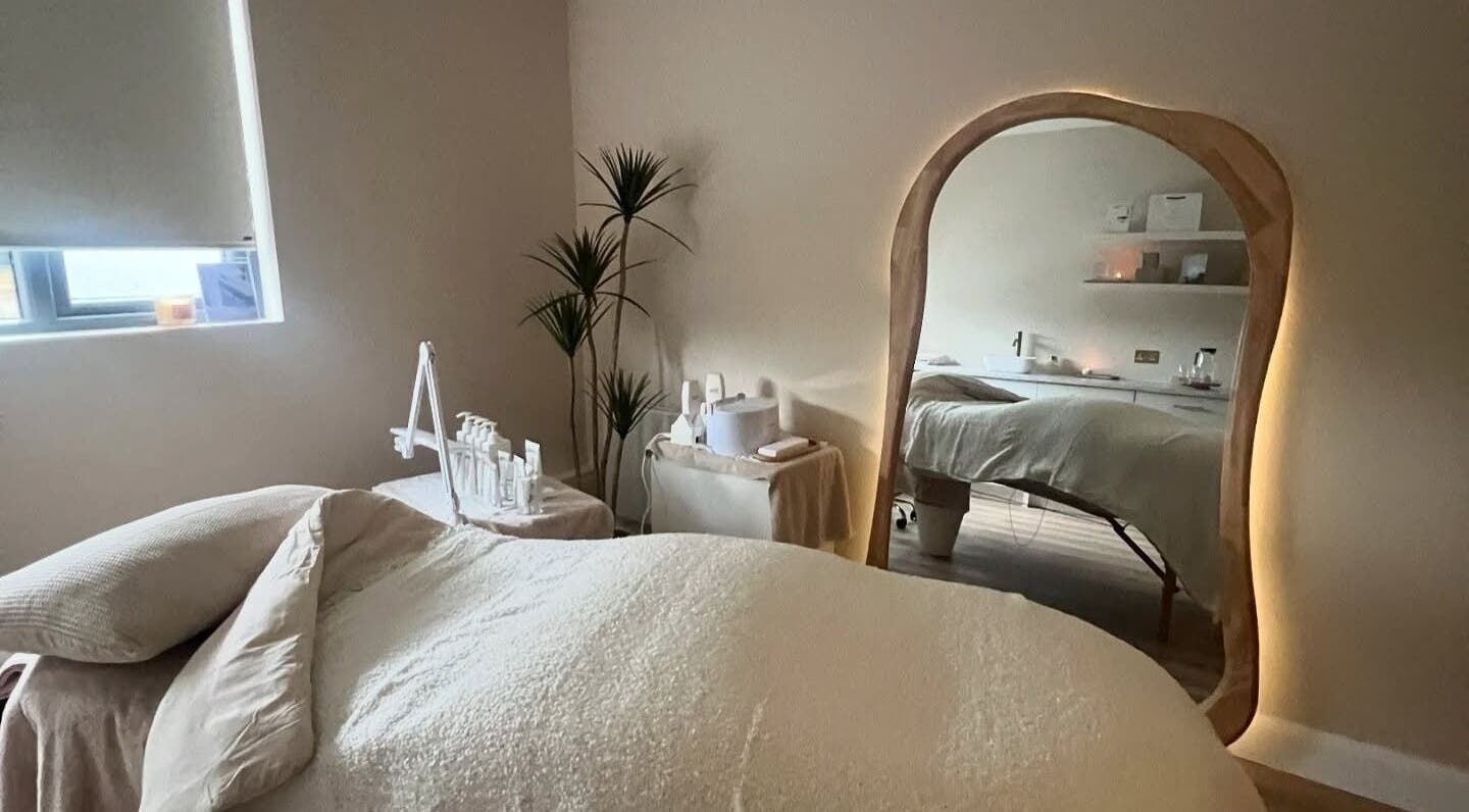 Relaxing treatment room at Beauty Lab in Drogheda, IE with soft lighting and a cozy bed.