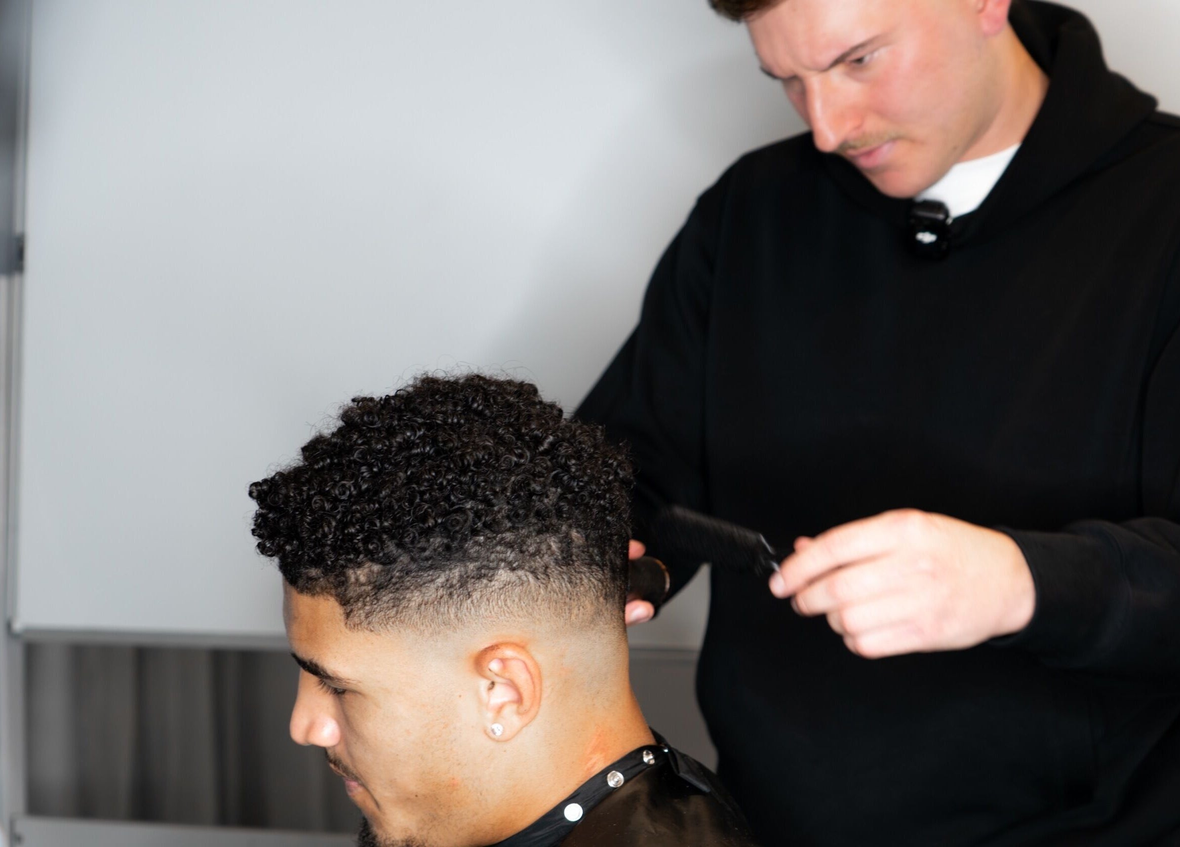 A stylist crafting a fresh haircut at FLETCHCUTZ, Woodvale, Western Australia, AU.