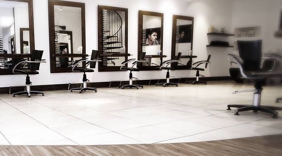 Modern styling chairs at Roma Hair Salon Aveda in Torquay, England, GB. Sleek interior design visible.