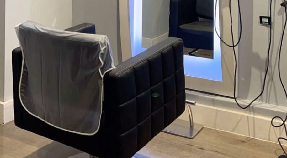 Modern salon chair at Infinity Hair in Littleport, England, GB, with sleek mirror and stylish setup.