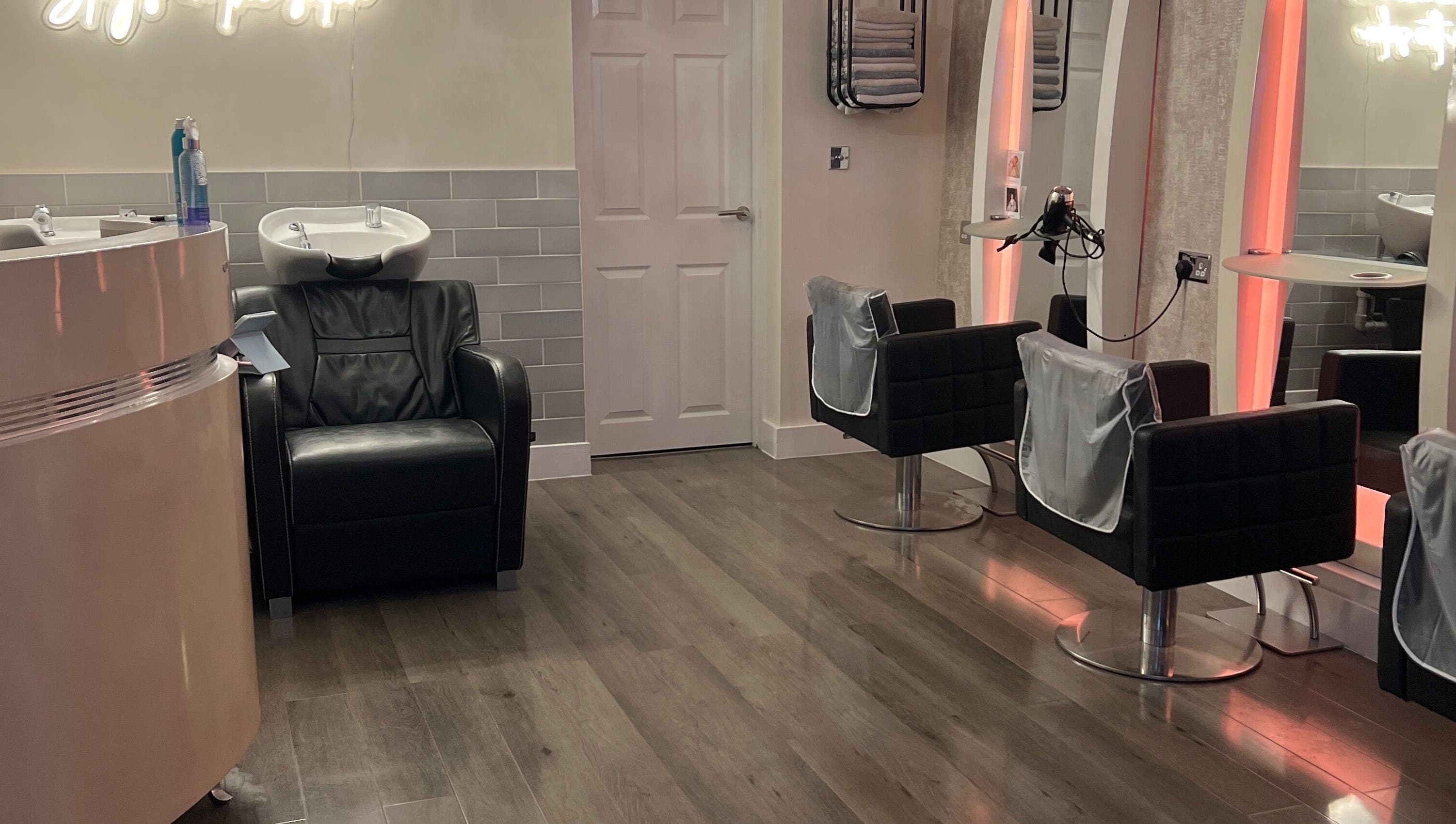 Infinity Hair salon in Littleport, England features modern chairs and hair wash stations in a chic, welcoming layout.