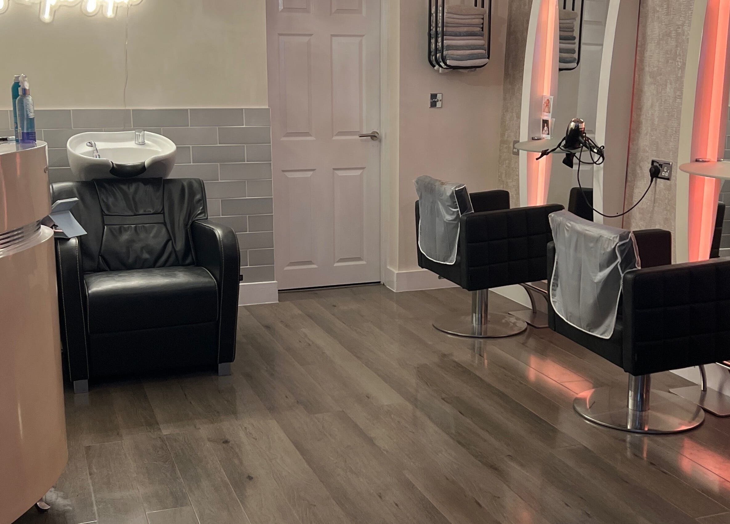Infinity Hair salon in Littleport, England features modern chairs and hair wash stations in a chic, welcoming layout.