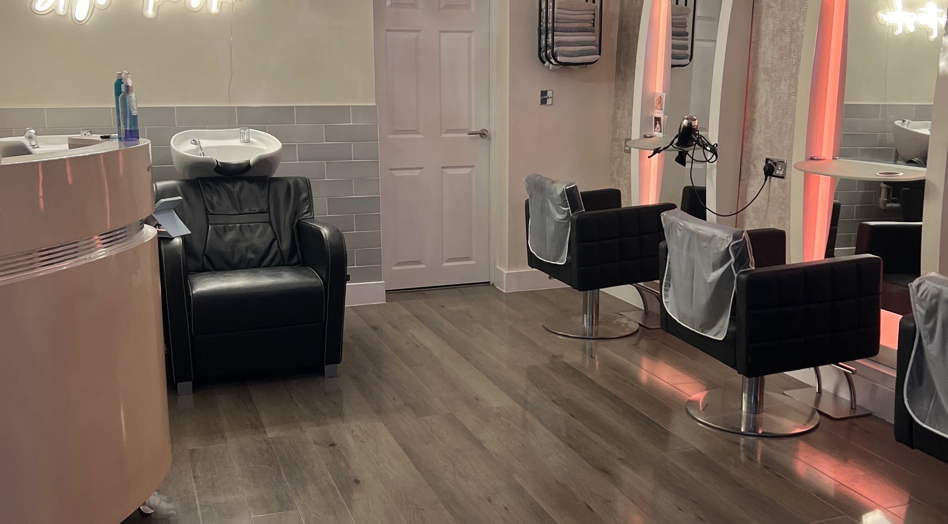 Infinity Hair salon in Littleport, England features modern chairs and hair wash stations in a chic, welcoming layout.