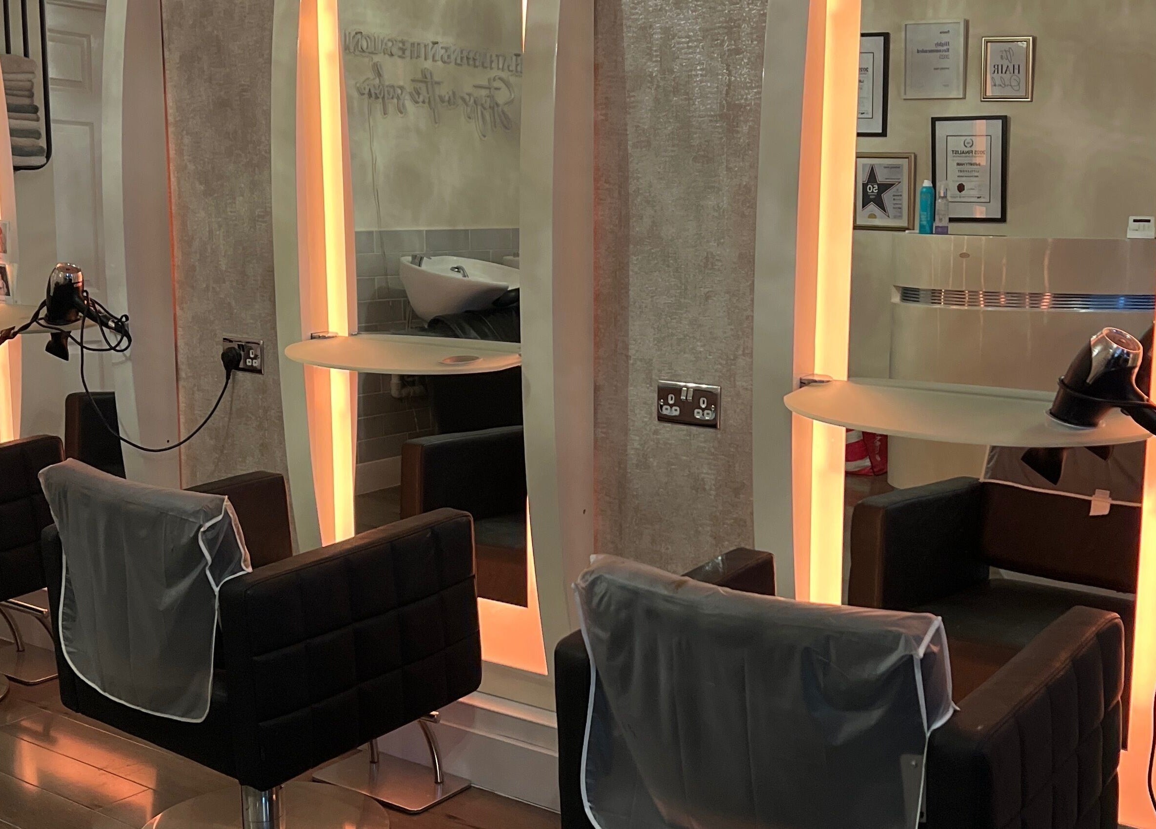 Modern salon chairs and mirrors at Infinity Hair, Littleport, England, GB.