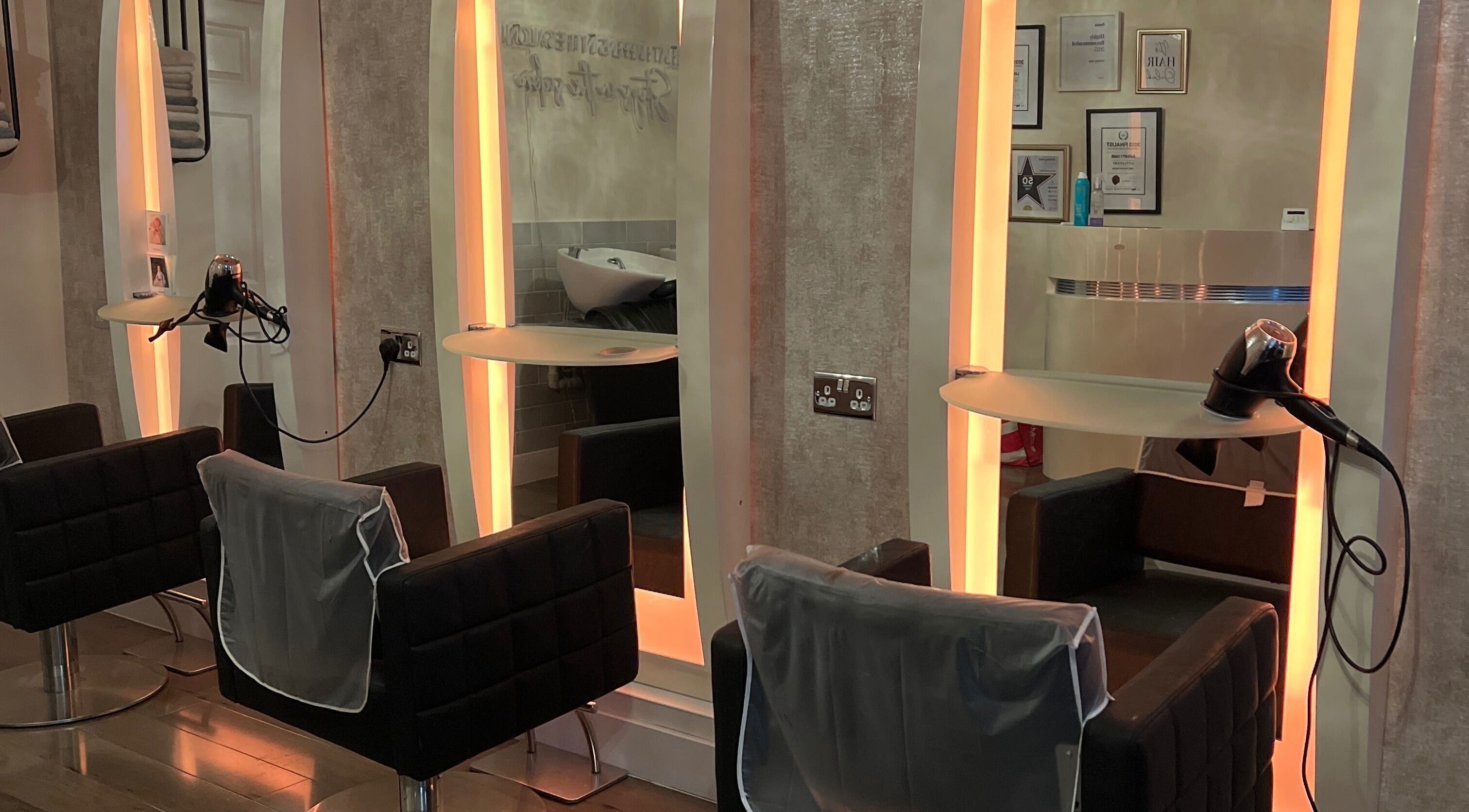 Modern salon chairs and mirrors at Infinity Hair, Littleport, England, GB.