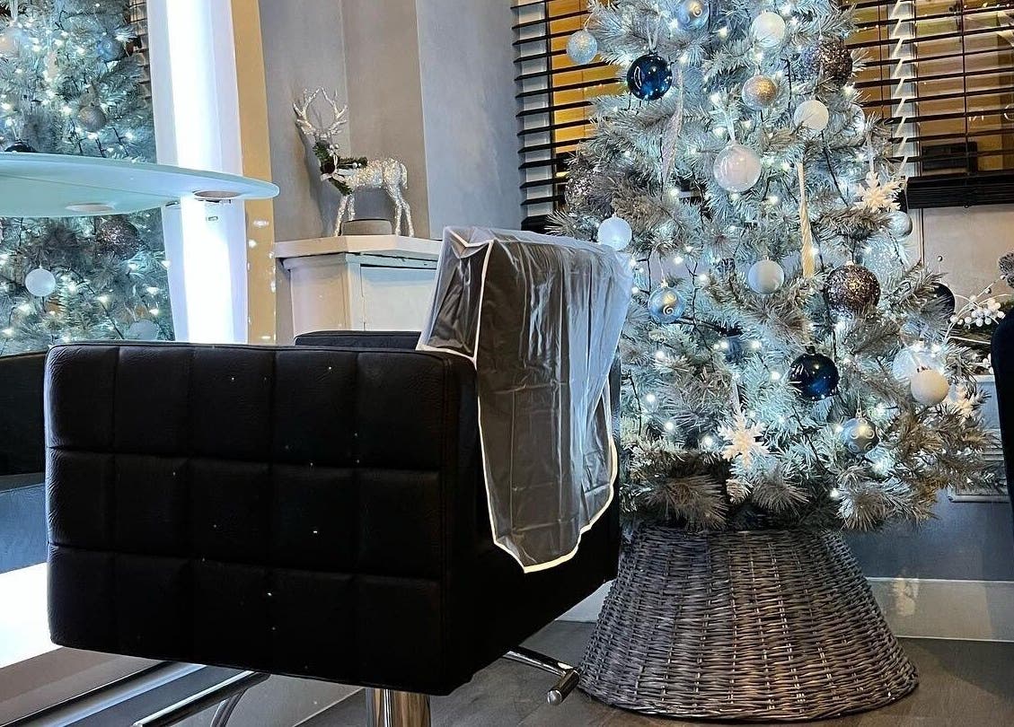 Infinity Hair salon in Littleport, England, GB, showcasing a chic hair station with a festive Christmas tree.