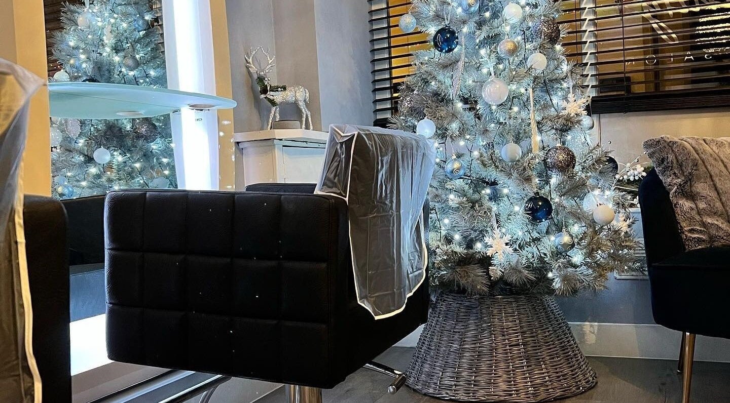 Infinity Hair salon in Littleport, England, GB, showcasing a chic hair station with a festive Christmas tree.