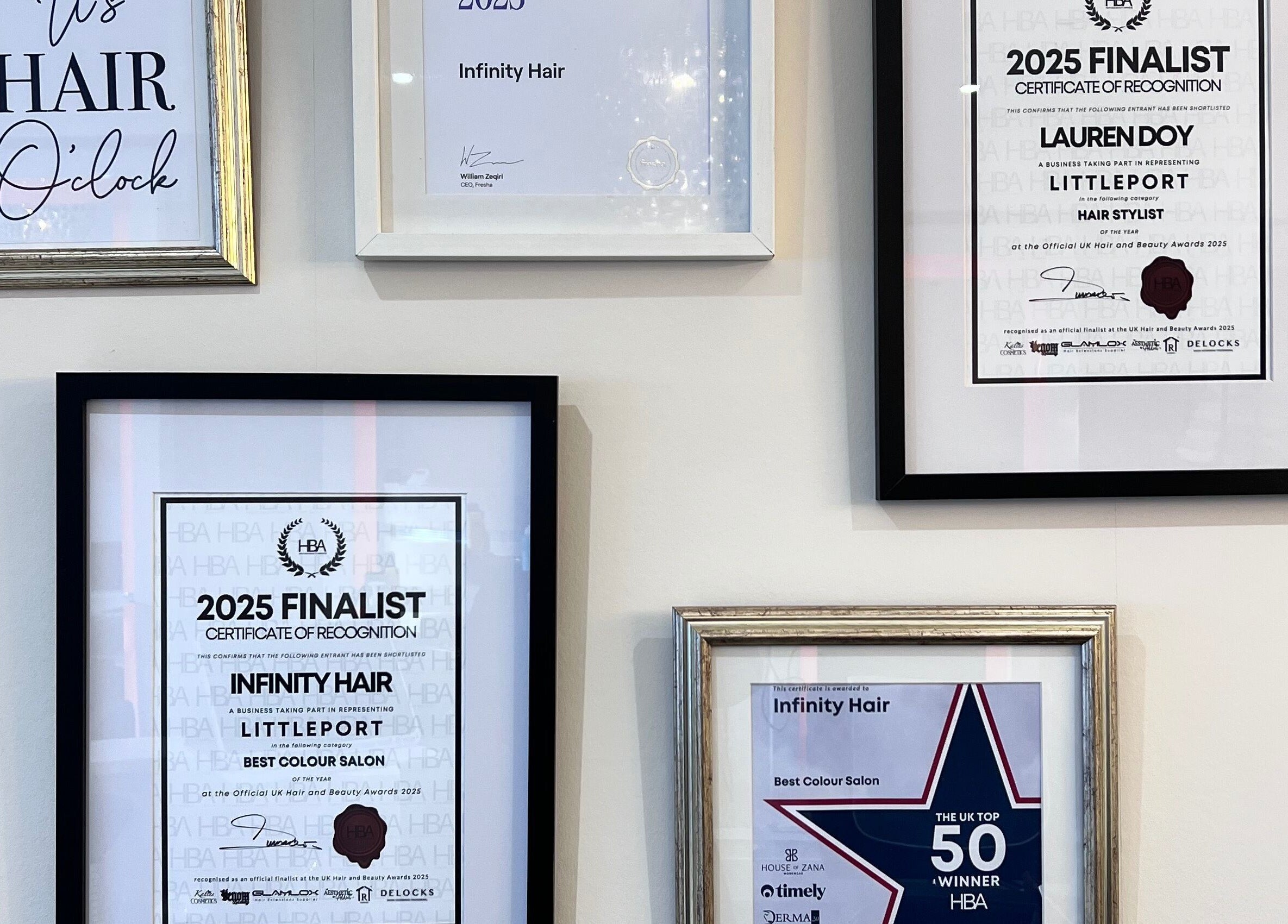 Infinity Hair award certificates proudly displayed on a wall in Littleport, England, GB.