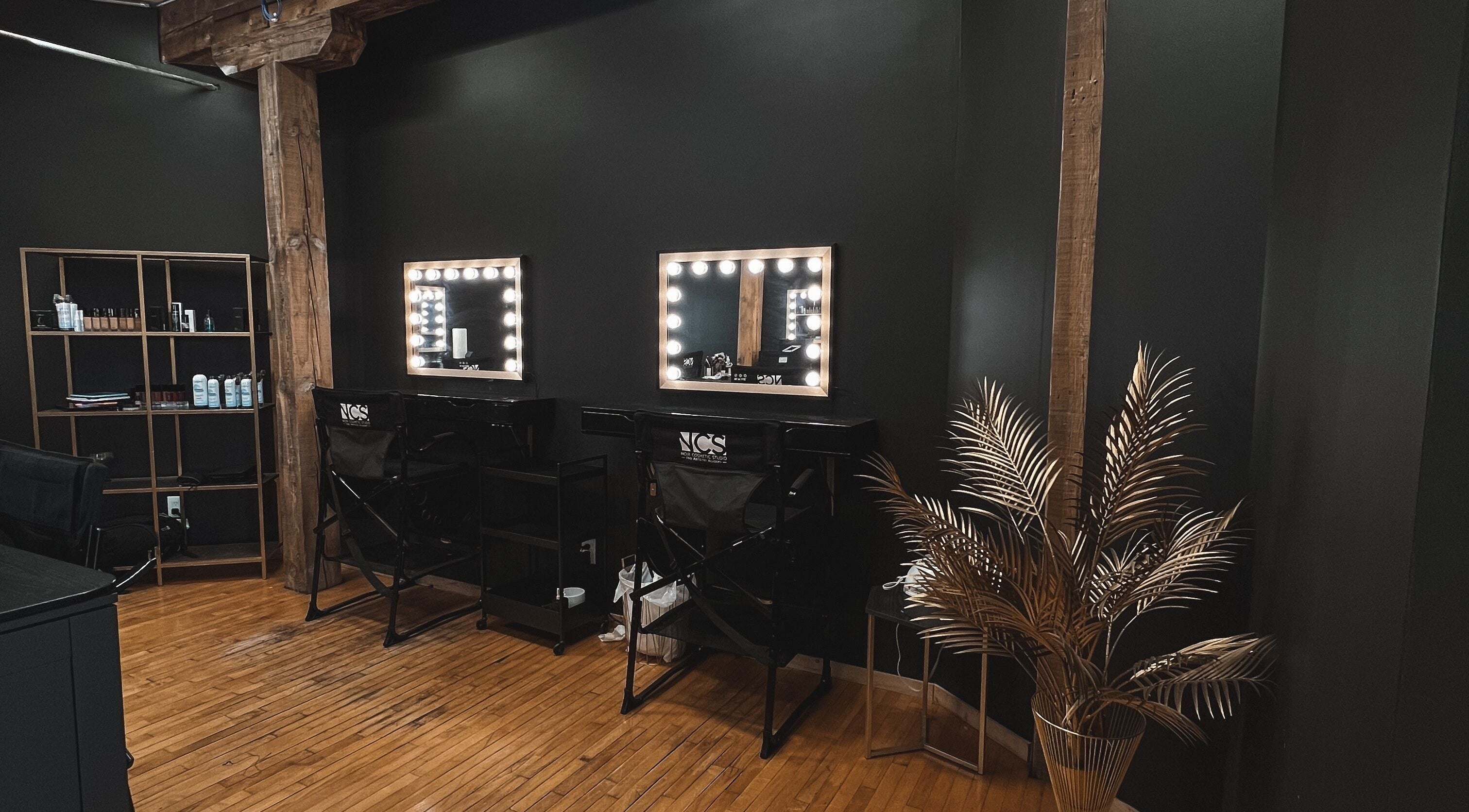 Luxurious vanity stations at Noir Beauty Lounge, Winnipeg, Manitoba, CA featuring elegant lighting and decor.