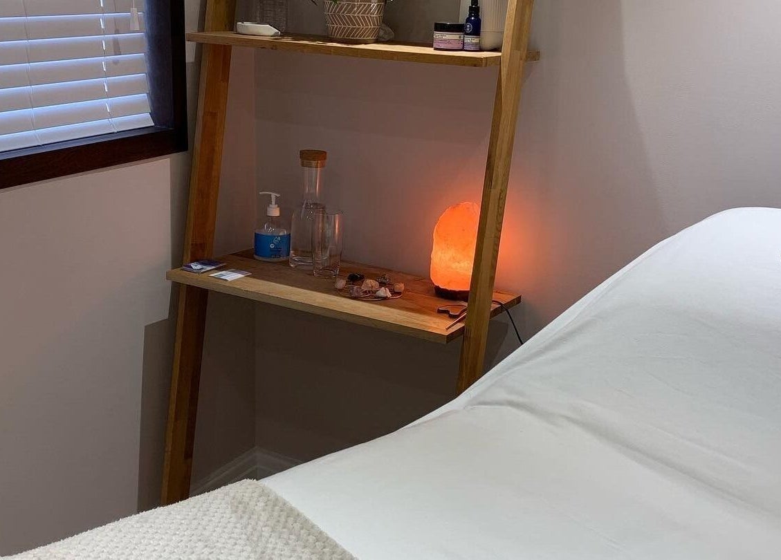 Cozy treatment room at Living Well Reflexology in Mickleton, England, GB with a massage bed and a warm ambiance.