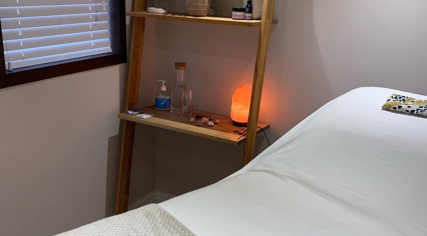 Cozy treatment room at Living Well Reflexology in Mickleton, England, GB with a massage bed and a warm ambiance.