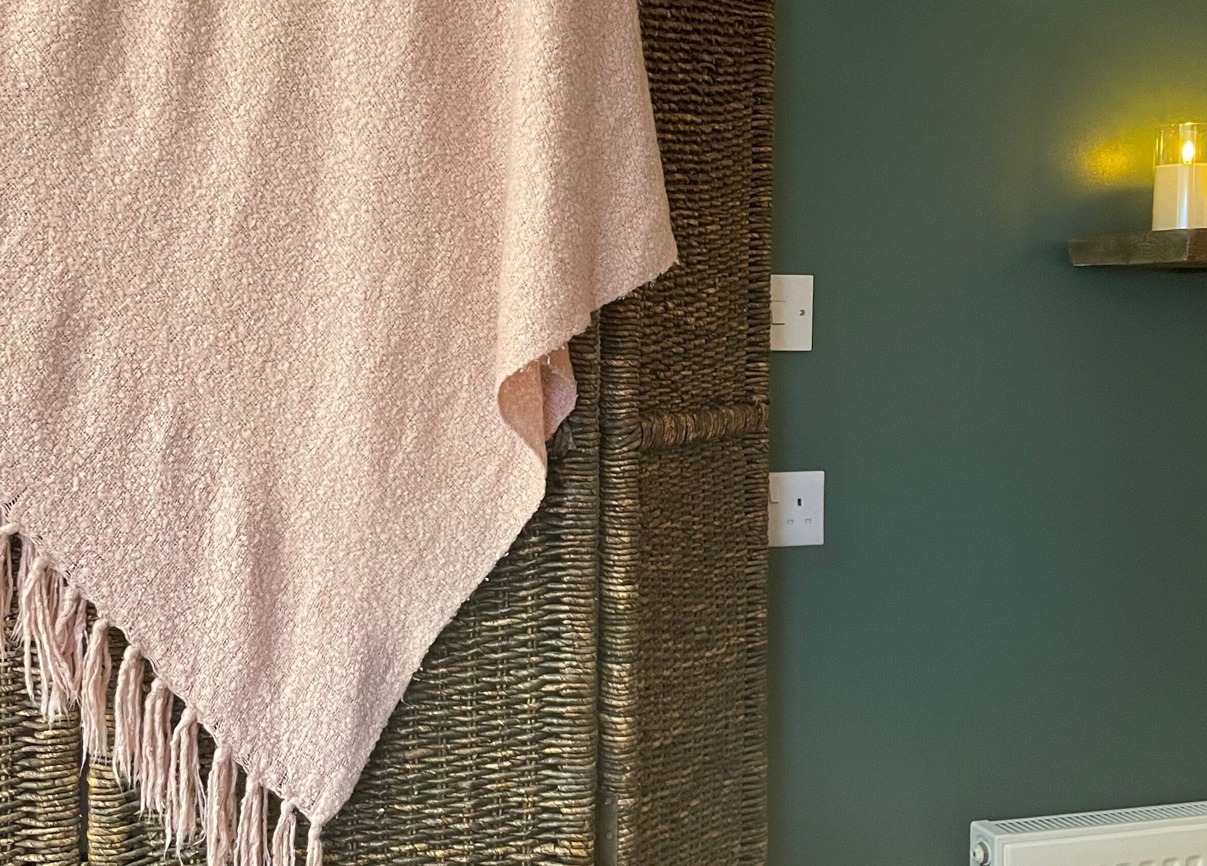 Cozy woven wall and candles at Living Well Reflexology in Mickleton, England, GB.